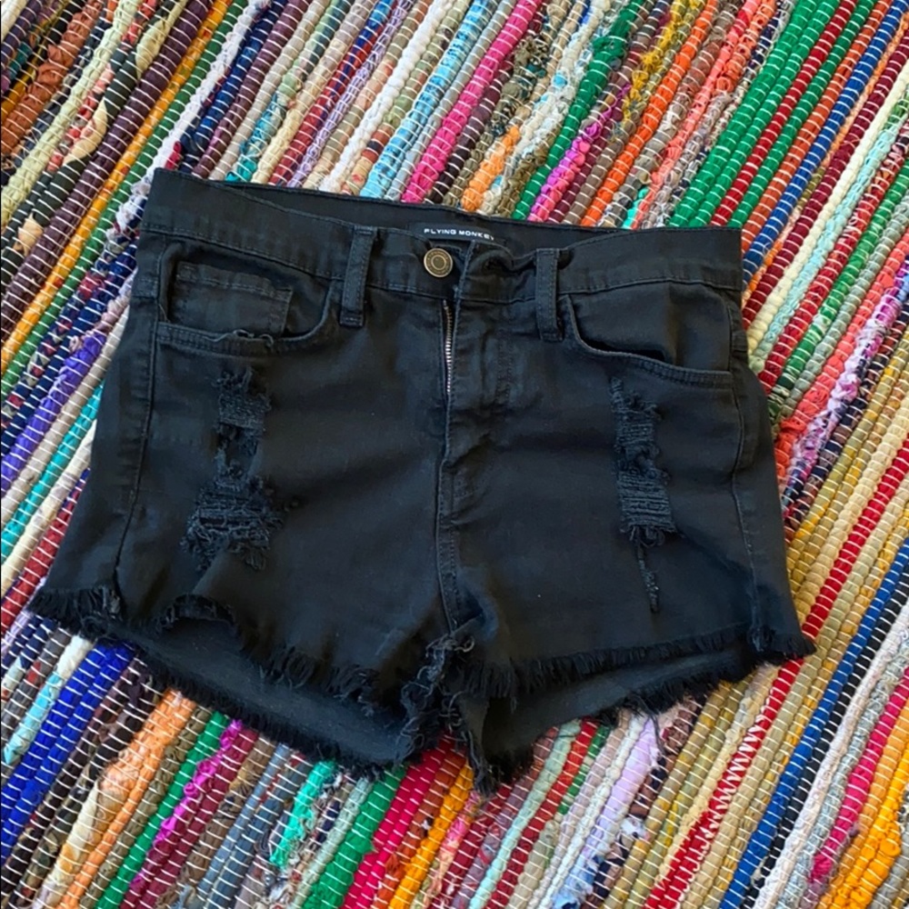 Distressed black denim cutoffs